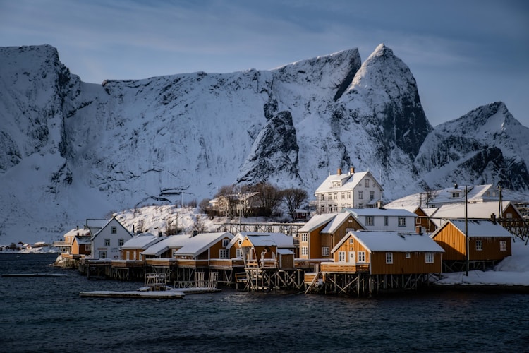 A group of houses sitting on top of a snow covered mountain
