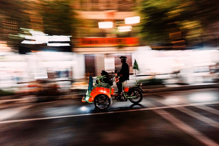 A blurry photo of a person on a bike