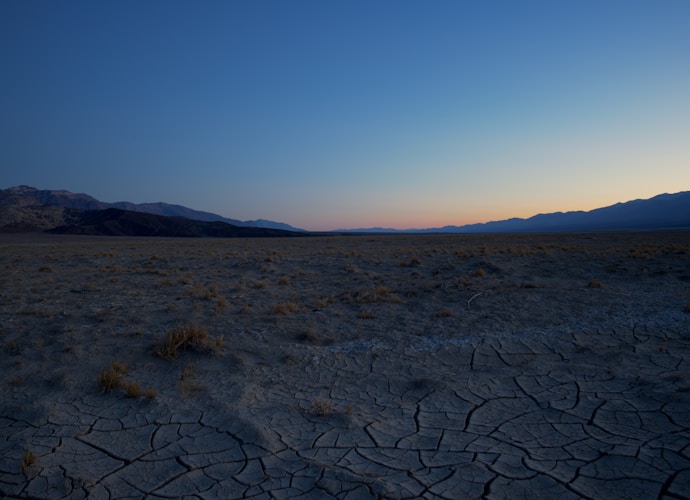 A desert landscape with mountains in the distance