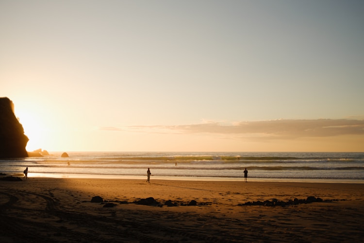 Sunset casts a golden glow over a beach.