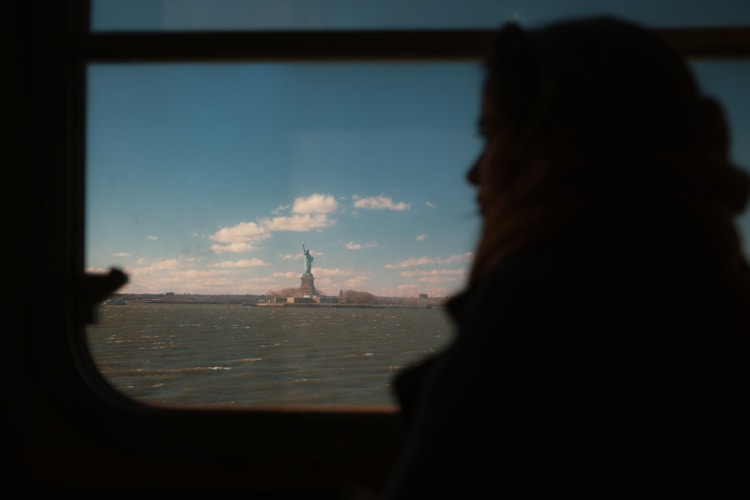 A person gazes at the statue of liberty.
