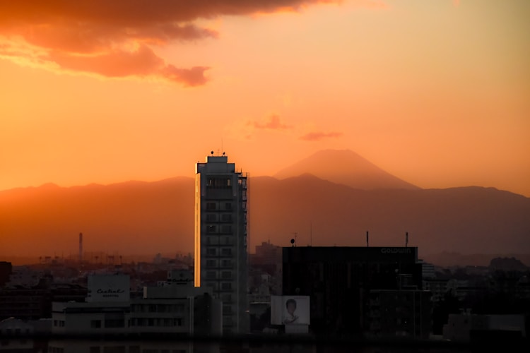 Sunrise bathes the city with warm orange hues.