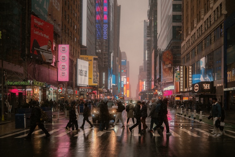 People cross a busy street in a city.