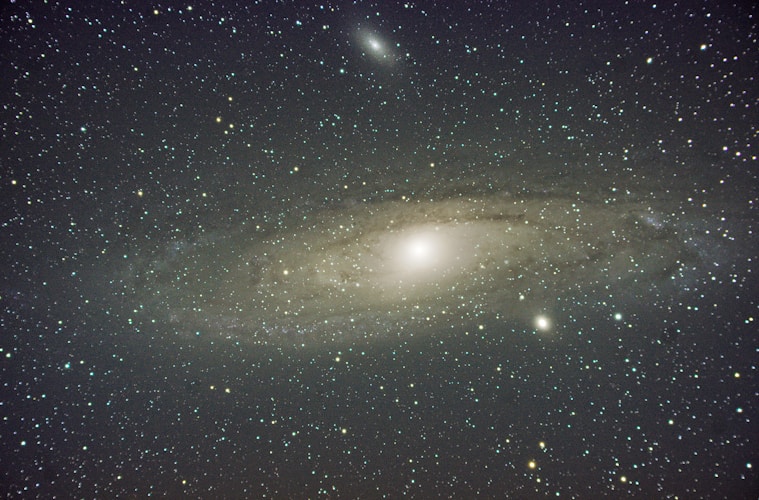 The andromeda galaxy shines brightly among stars.