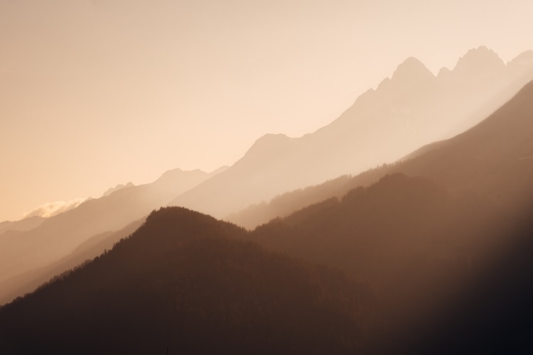 Mountains silhouetted in misty layers.