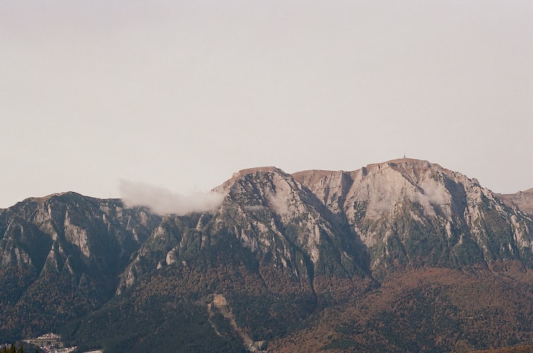 Mountains are seen with a cloudy sky above.
