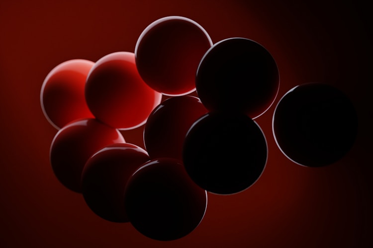 Red spheres against a dark red background.