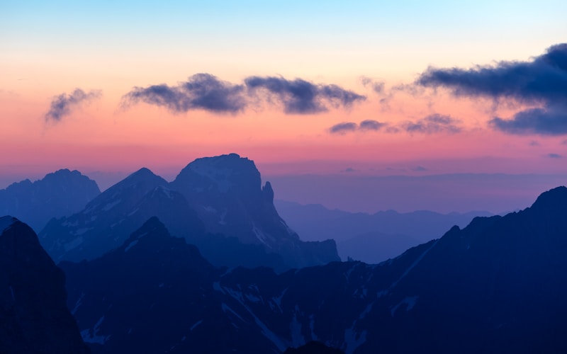 Mountains stand out against a colorful sunset.