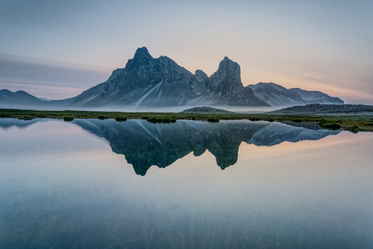 Mountains reflect beautifully on the calm water's surface.